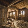 The interior of Mrs. Hoyer's guest house before restoration, visible board walls, floors, ceilings