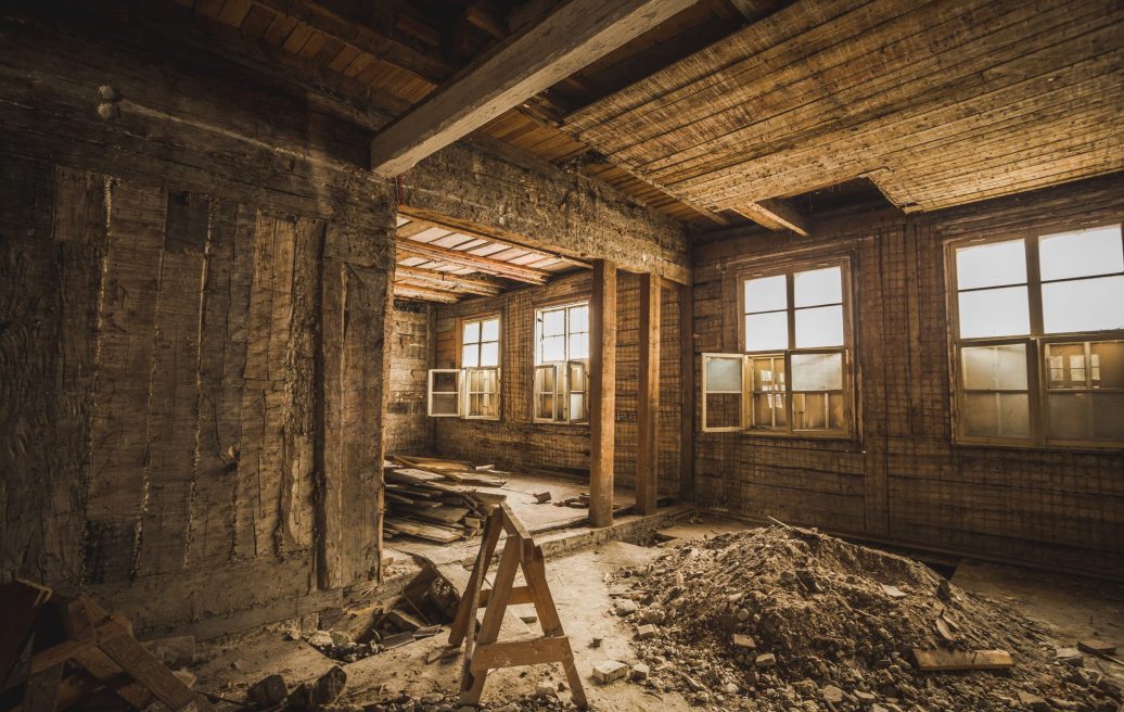 The interior of Mrs. Hoyer's guest house before restoration, visible board walls, floors, ceilings