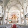 The interior of Liepāja's Holy Trinity Cathedral shows an exquisite design with luxurious gold elements and a white exterior.