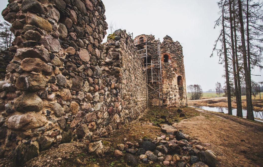 The North tower of the medieval castle of Ergeme from another point of view with racks and a zoomed-in wall