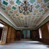 The main room of Sigulda New Palace with two chandeliers and a luxurious ceiling design