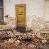 Stamerien Castle before restoration with a small wooden door with no stairs leading up to it