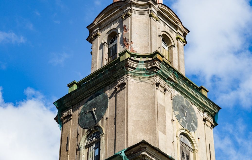 The tower of the Holy Trinity Cathedral of Liepāja before restoration with blue sky and clouds in the background