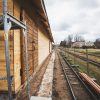 Alūksne Station Barn next to the train tracks with fencing