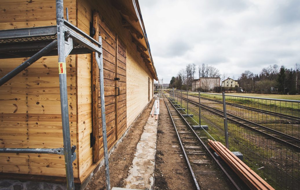 Alūksne Station Barn next to the train tracks with fencing