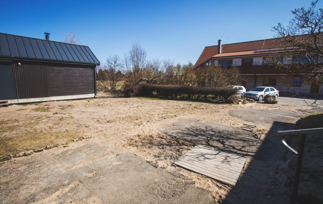 Pavilosta flood protection building parking lot with two already parked cars