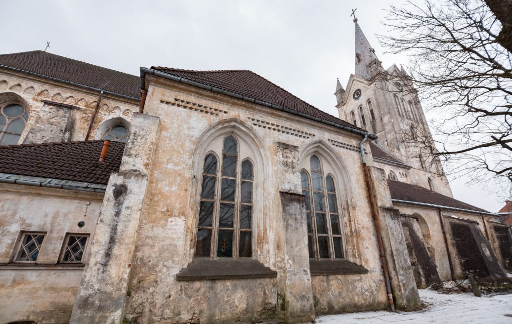 St. John's Church from the outside with a view of the church windows and the church spire with a snowy road