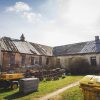 The courtyard of the Firks-Pedvāle manor with the building before the restoration