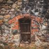 The passage of the southern tower of Alūksne Castle, which is walled up with wooden boards