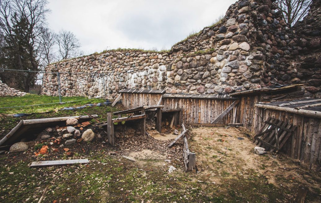 The wall of the southern tower of Alūksne Castle with a fenced area