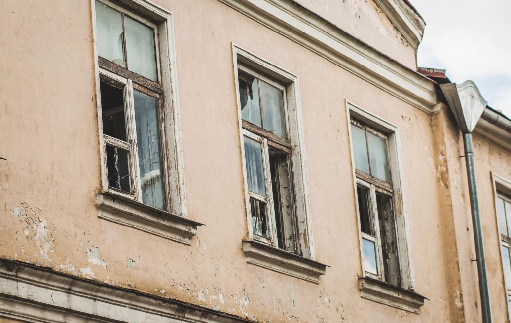 The building of The Kuldīga Needle Factory before renovation with three window close-up