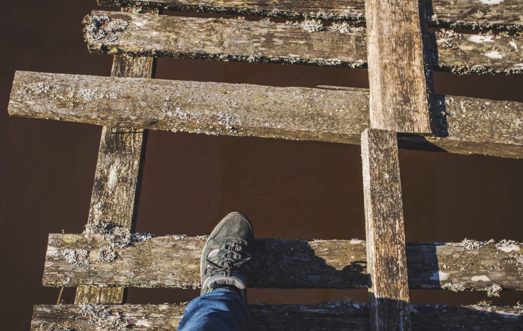 The Irbe Footbridge with a human leg and a missing wooden plank