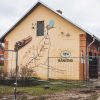 A mural with a bus stop map and a train at Alūksne Station Barn