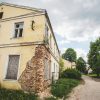 Exterior view of The Kuldīga Needle Factory with damaged wall