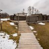 Āraiši Lake Castle Archaeological Park with snow-covered hills