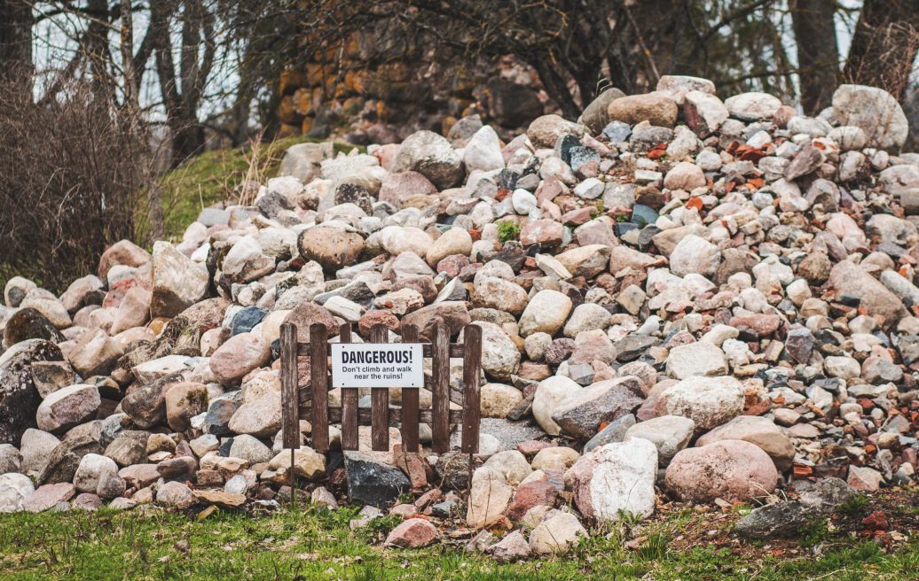 The crumbling stones of the wall of the southern tower of Alūksne Castle, on which it is forbidden to climb