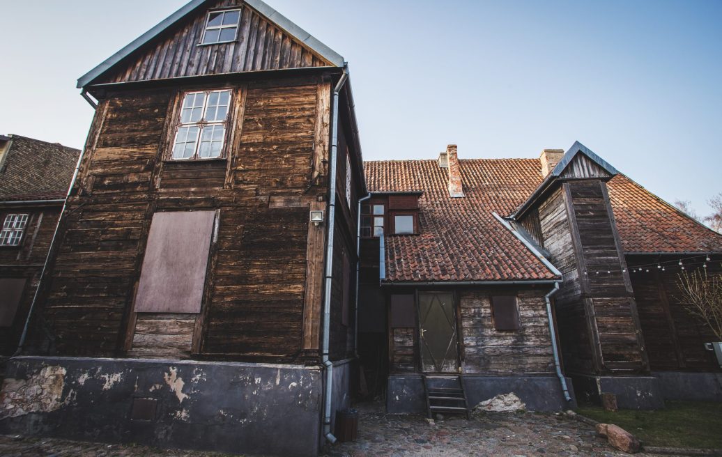 Mrs. Hoyer's guest house before restoration with a blue sky in the background