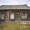 A house with three windows and a damaged roof of the Farmstead Slutišķi 2