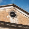 The round window of the roof of the Firks-Pedvāle manor before the restoration of the building