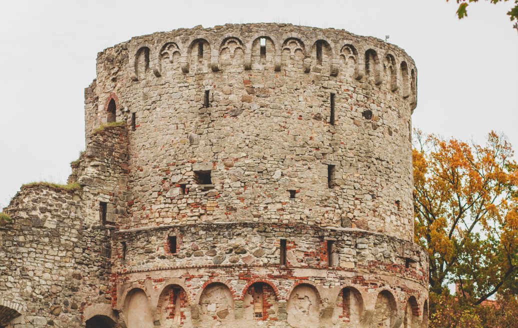 A close-up of the medieval castle tower of Cēsis, showing brick and stone details