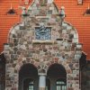 Masonry wall of Cesvaine Castle with embedded coat of arms