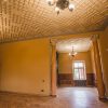 The renovated room of Sigulda's New Castle is yellow with a white ceiling and two chandeliers