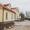 Fircks-Pedvāle Manor House yard with a white entrance gate