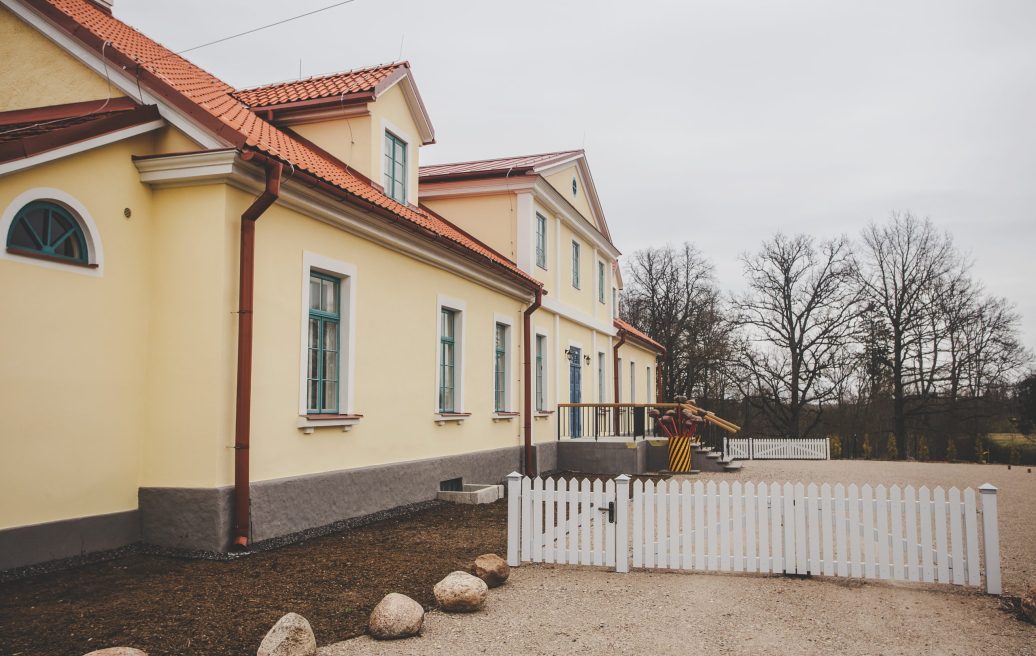 Fircks-Pedvāle Manor House yard with a white entrance gate