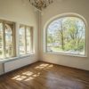 The renovated room of the Dundaga Castle with wide windows that offer a beautiful view of the Latvian summer