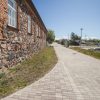 The road that leads along the anti-flood promenade of Pāvilosta in summer