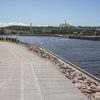 The shore of the Pāvilosta anti-flood promenade with a pedestrian path