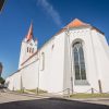 St. John's church window and church building in white