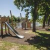Children's playground with a slide in Grobiņa archaeological ensemble in summer