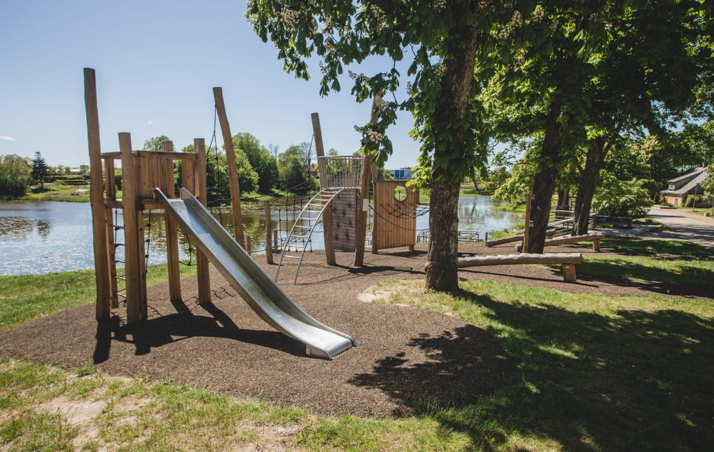 Children's playground with a slide in Grobiņa archaeological ensemble in summer