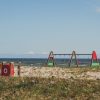 The dune area of Engure Beach. A swing and a children's playground