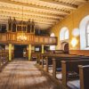 Rubene Evangelical Lutheran Church from the inside showing the chandelier, church windows, seating for visitors, ceiling