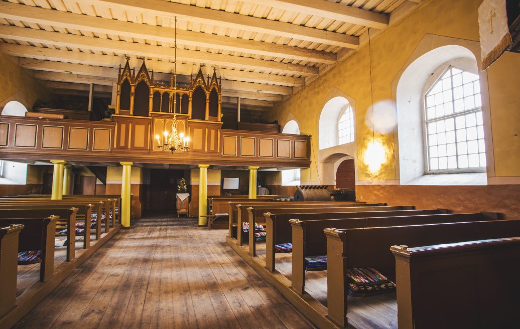 Rubene Evangelical Lutheran Church from the inside showing the chandelier, church windows, seating for visitors, ceiling