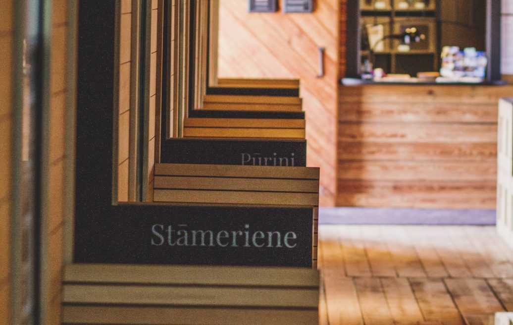 The names of the stops on the backs of the chairs in Alūksne Station Barn