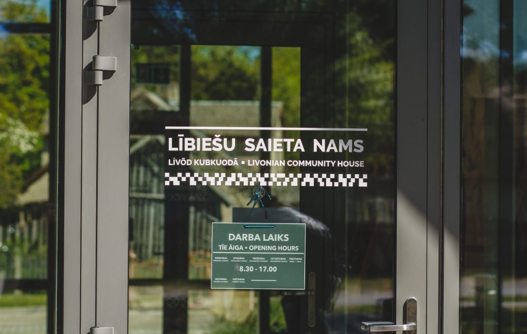 The entrance door of The Kolka Livonian Meeting House and information about working hours