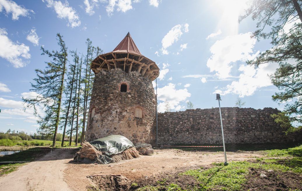 View of the Northern Tower of Ērģeme Medieval Castle with an attached tower roof and a fence that cannot be crossed