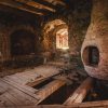 The interior of the Northern Tower of Ērģeme Medieval Castle with wooden floors and a window