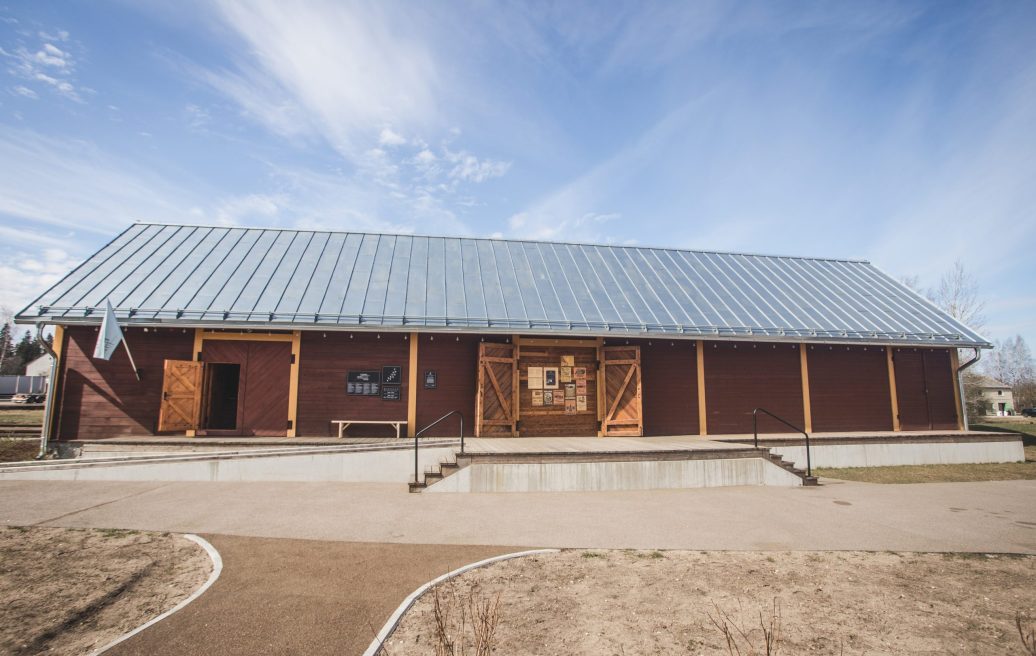 Alūksne Station Barn a building from the side with an information board