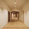 Dundaga Castle hallway with wooden floors and white walls