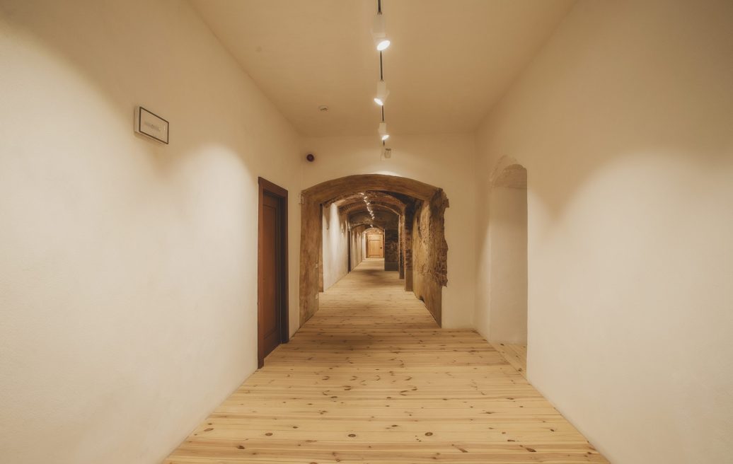 Dundaga Castle hallway with wooden floors and white walls