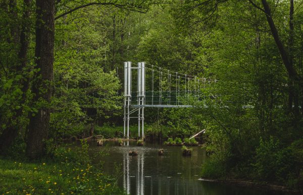 Footbridge over the Irbe river in the landscape